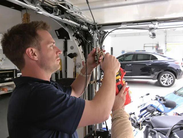 North Olmsted Garage Door Repair safety certified technician performing cable replacement in North Olmsted